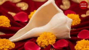A beautifully decorated Dakshinavarti Shankh placed beside a Tulsi plant and diya